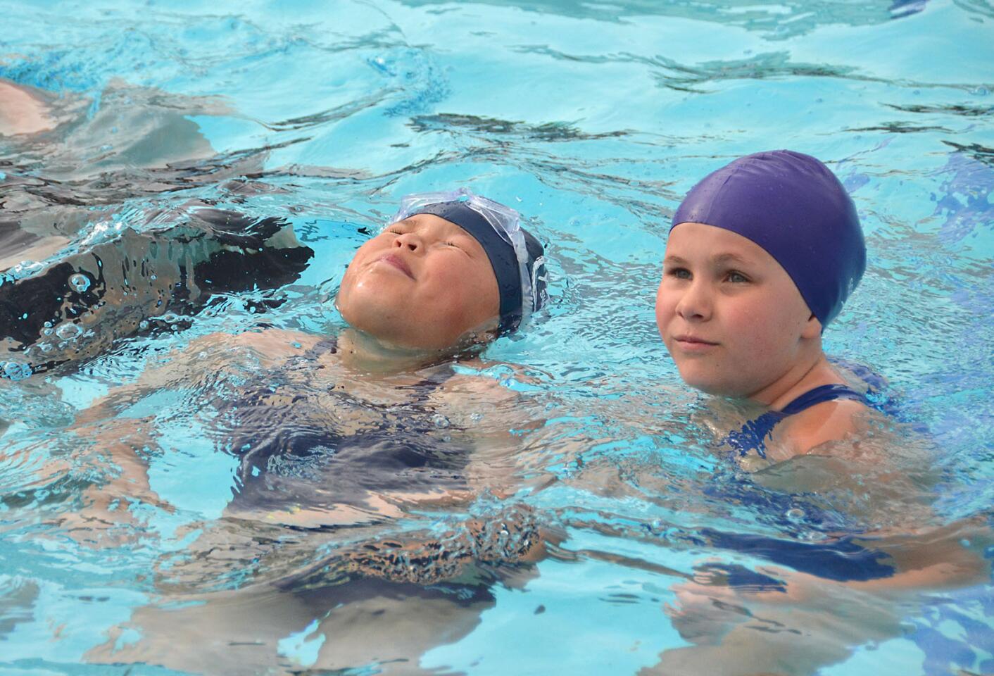 Nine year old Sharlene Stedfield, center, reclines in the water during the treading water phase of the final junior lifeguard tryouts held Sunday at CDMHS.