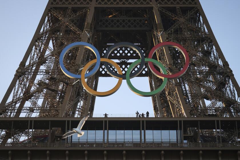 FILE - The Olympic rings are mounted on the Eiffel Tower Friday, June 7, 2024 in Paris.