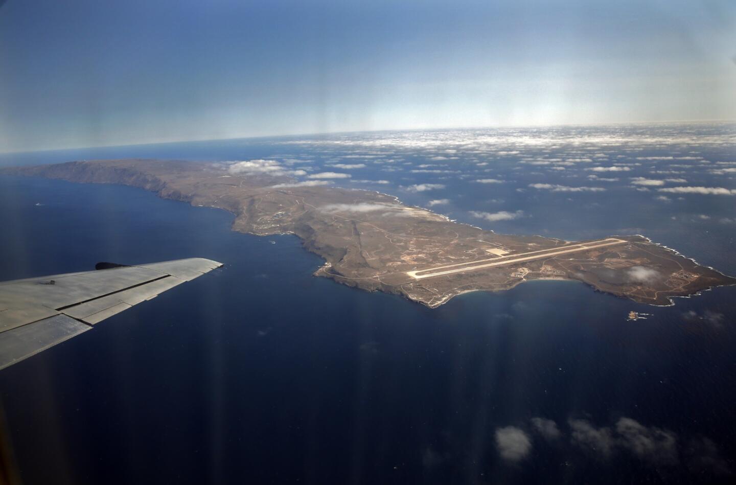 San Clemente Island, viewed from a shuttle aircraft that regularly flies military and civilian personnel to the U.S. Navy-owned land mass 68 miles from San Diego. The military airstrip is seen at the northern end. The southern end has the only remaining ship-to-shore bombardment range in the U.S. The Navy has supported an extensive ecological restoration of endangered plants and animals on the island. [For the record, July 24, 2013: An earlier version of this caption incorrectly said the military airstrip was at the southern end of the island, and the bombardment range to the north.]