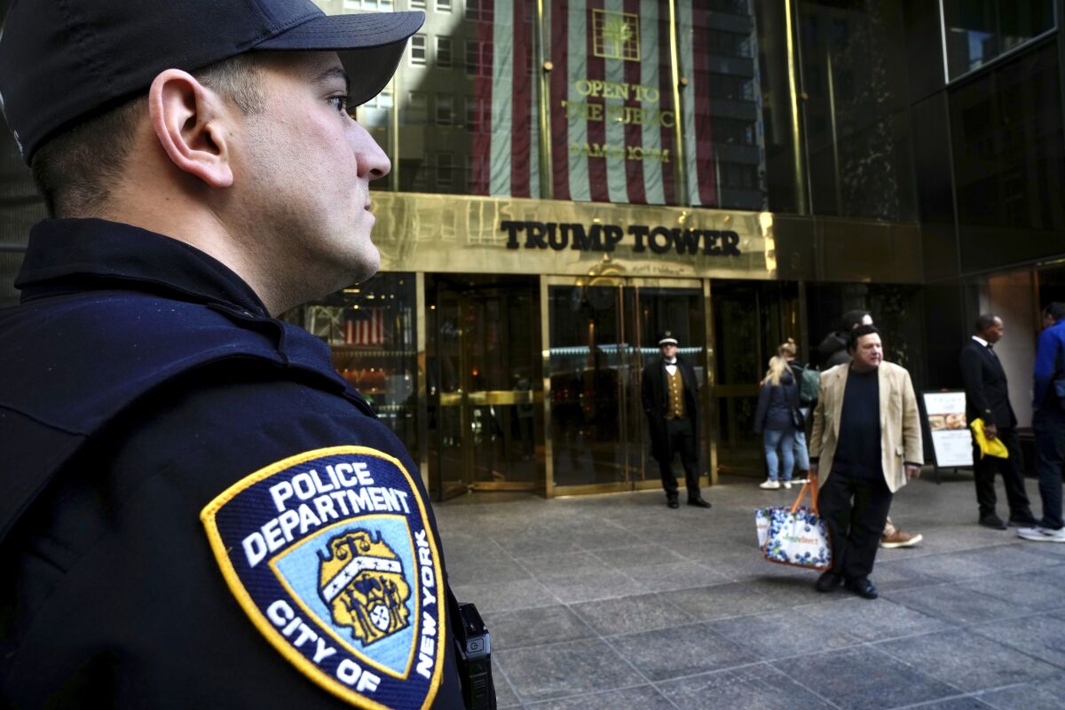 A member of the NYPD stands outside of Trump Tower on Wednesday, March 22, 2023, in New York. (AP Photo/Bryan Woolston)