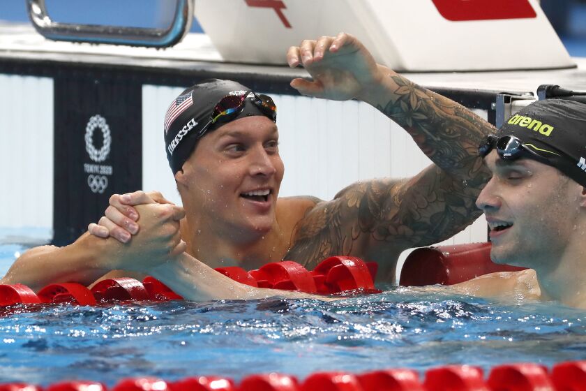 TOKYO, - JULY 31: U.S. swimmer Caeleb Dressel congratulates Kristof Milak.