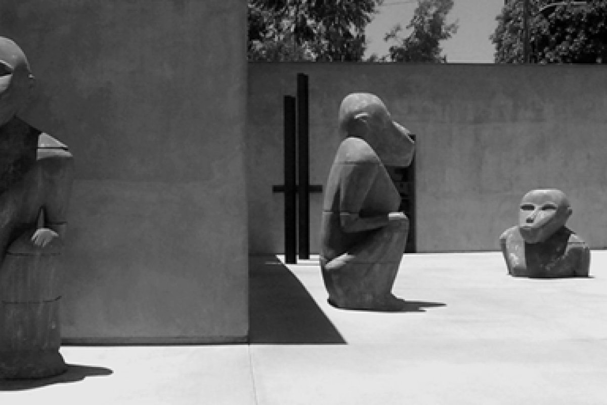 A black-and-white photo of babboon sculptures in a store courtyard.