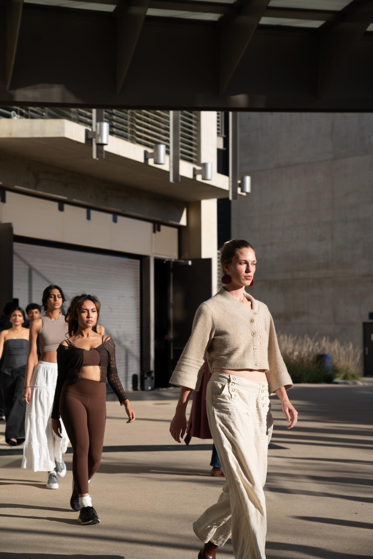 Models walk in a fashion show.