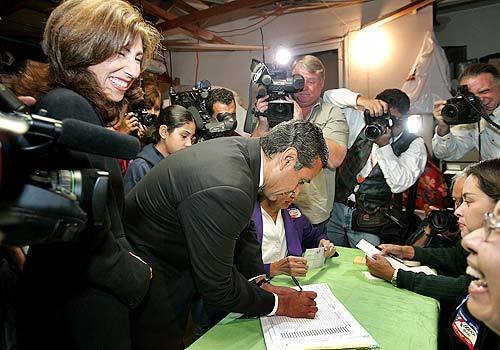 Mayoral candidate Antonio Villaraigosa signs in at his polling place in Glassell Park with his wife, Corina.