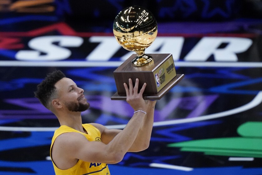 Golden State Warriors guard Stephen Curry celebrates after winning the three-point contest.