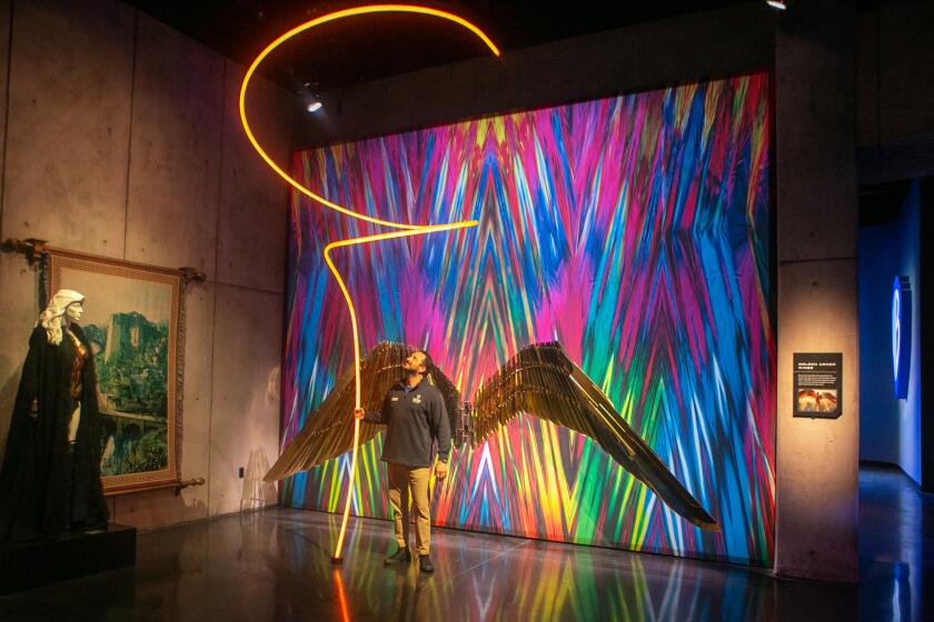 BURBANK, CA - JUNE 01: VIP studio and backlot tour guide John Kourounis engages with one of the many interactive exhibits at Warner Brothers new welcome center that provides tour guest with an expanded experience on Tuesday, June 1, 2021 in Burbank, CA. (Jason Armond / Los Angeles Times)