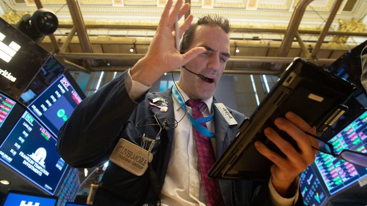 Traders work on the floor of the New York Stock Exchange at the closing bell.