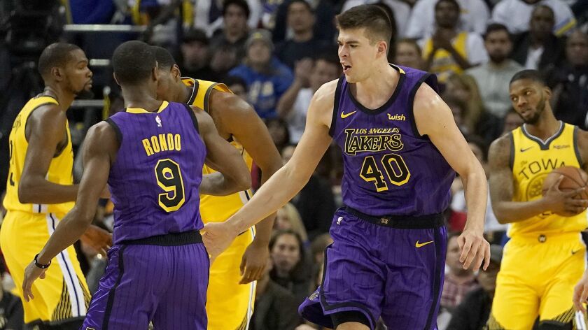 Lakers center Ivica Zubac (40) is congratulated by guard Rajon Rondo after making a shot against the Warriors during the second half Tuesday.