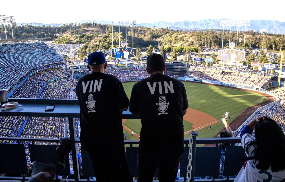 Dodgers fans wear VIN shirts in honor of Vin Scully during a pregame ceremony at Dodger Stadium.