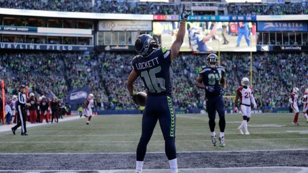 After signing a three-year deal with the Seahawks last offseason, wide receiver Tyler Lockett, center, has bought a modern farmhouse-inspired home outside Seattle for about $1.97 million.