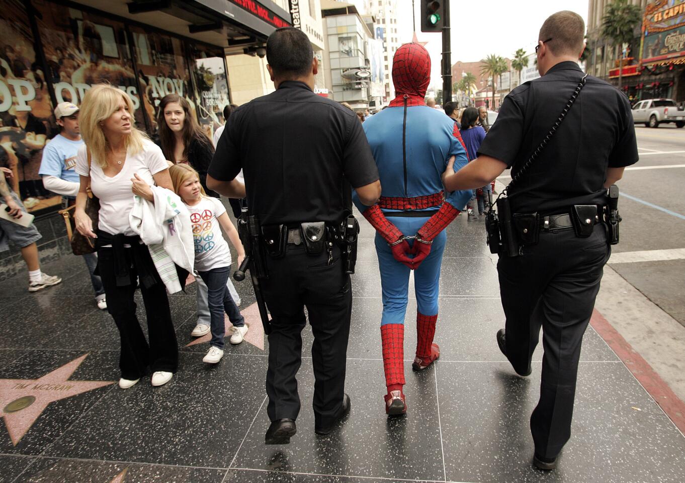 Officers from the Los Angeles Police Department arrest a man in a Spider-Man outfit after he allegedly assaulted a man on Hollywood Boulevard in 2009.