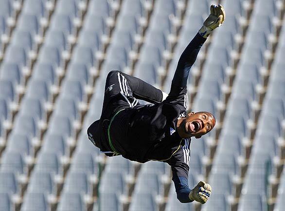 South Africa's goalkeeper Itumeleng Khune dives for the ball during a training session at Rand Stadium in Johannesburg. South Africa will face Brazil in a semifinal match in the Confederations Cup soccer tournament on Thursday.