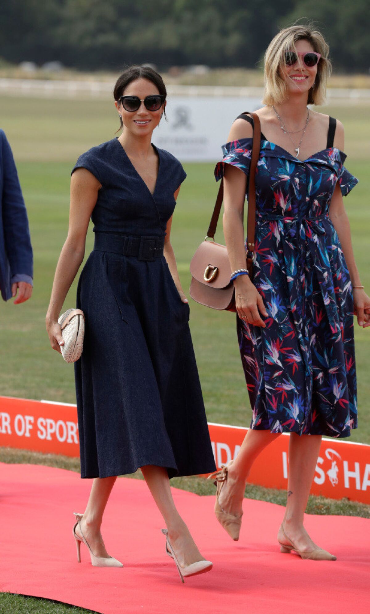 Meghan, Duchess of Sussex arrives with Delfina Blaquier, the wife of Nacho Figueras at the Royal County of Berkshire Polo Club in Windsor, England, to watch the Sentebale ISPS Handa Polo Cup where her husband Britain's Prince Harry is due to play.