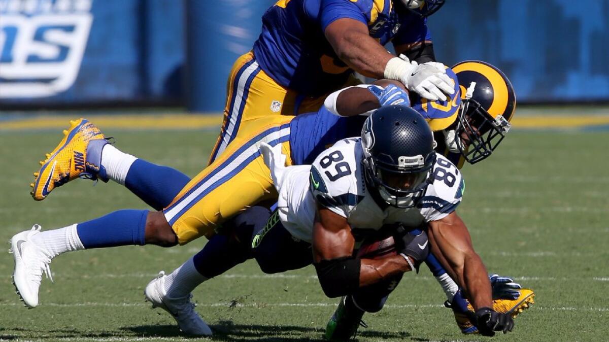 Rams cornerback Lamarcus Joyner and defensive tackle Aaron Donald tackle Seahawks receiver Doug Baldwin during a game on Sept. 18.