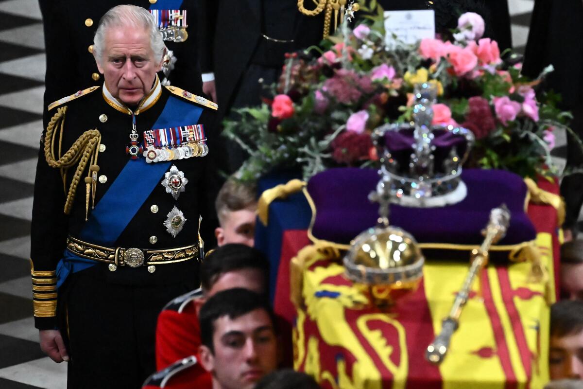 Britain's King Charles III walks beside the coffin of Queen Elizabeth II at Westminster Abbey in London on Sept. 19, 2022.