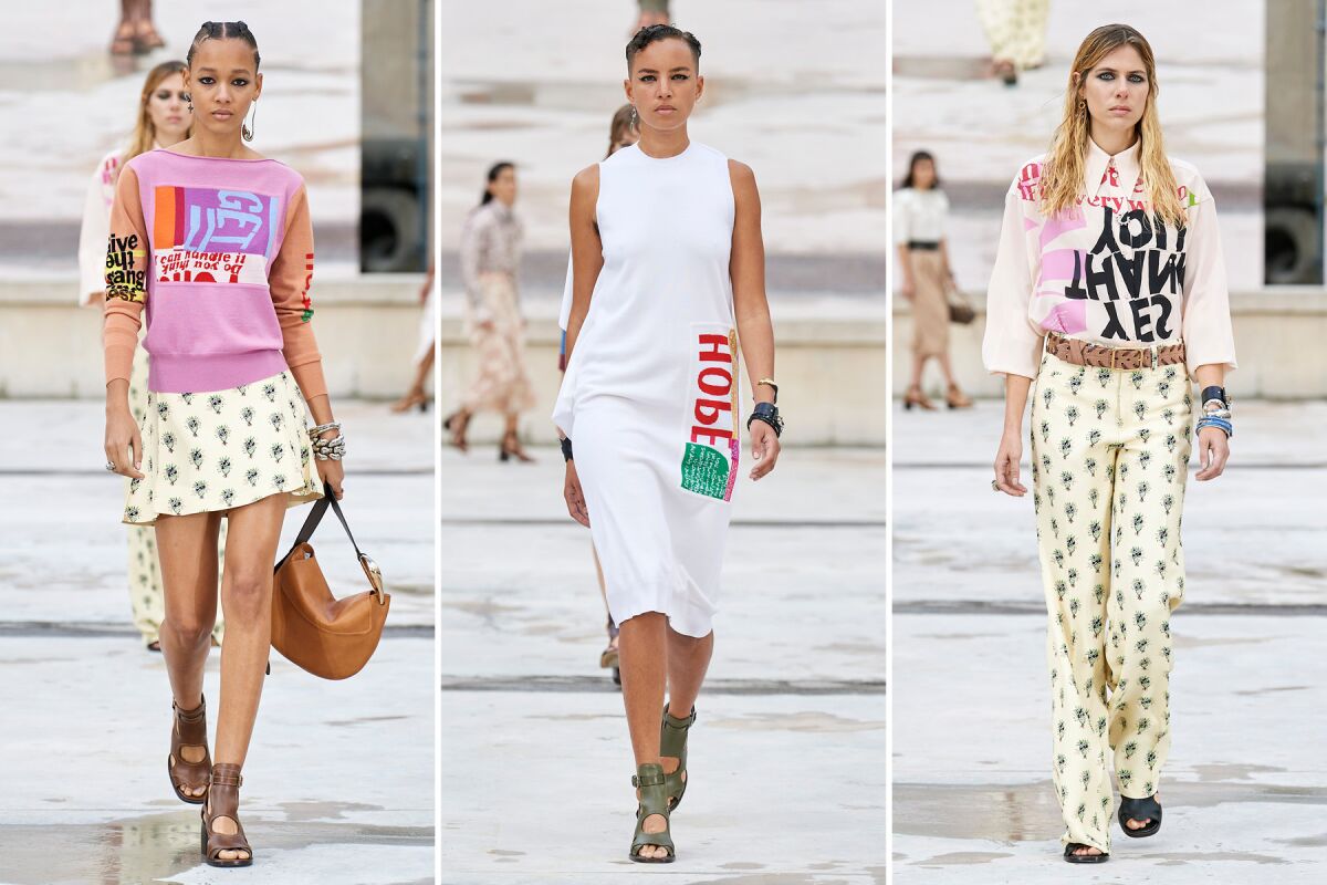 Three models in colorful graphics and floral prints on the runway at the Chloé runway show