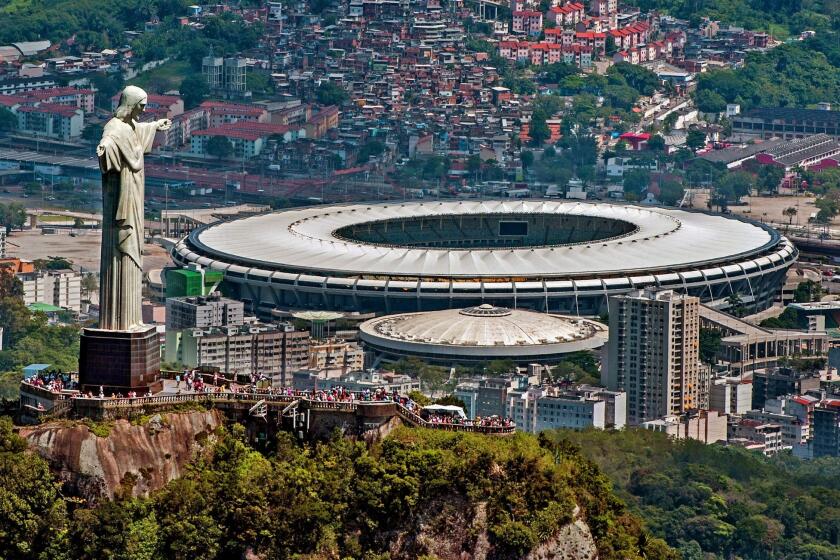 A statue of Christ the Redeemer atop Corcovado overlooks the Mário Filho (Maracanã) stadium in Rio de Janeiro. The Maracanã stadium will host both the Brazil 2014 FIFA World Cup and the 2016 Summer Olympics.