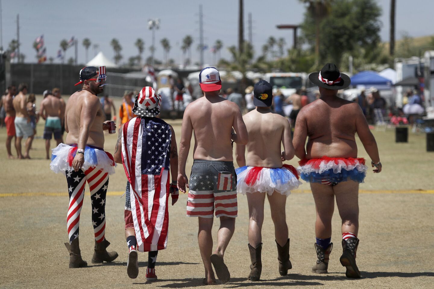 Men parade around the RV resort area Saturday supporting the spirit of USA.
