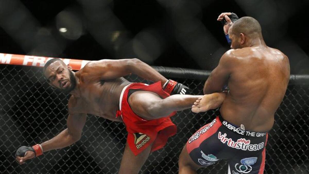 Jon Jones kicks Daniel Cormier during their light heavyweight title mixed martial arts bout at UFC 182 on Jan. 3, 2015.