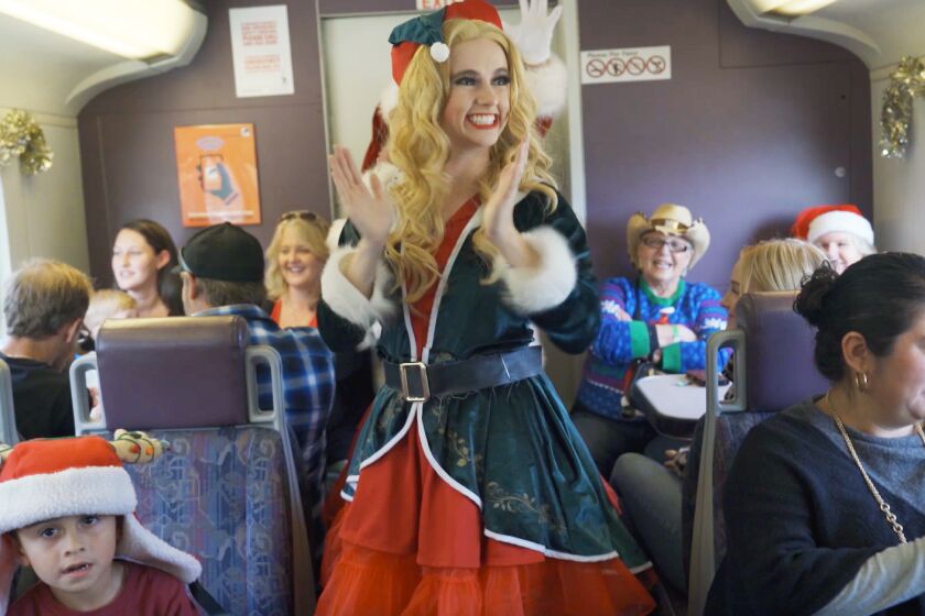 Santa's helper entertaining riders on the Metrolink's Holiday Express