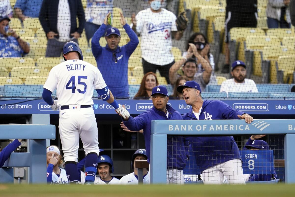 Dodgers first baseman Matt Beaty is congratulated by manager Dave Roberts.