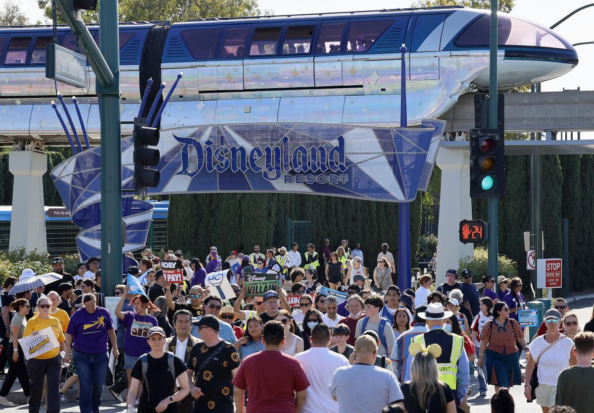 Disney workers rally outside the Harbor Boulevard entrance to Disneyland in a contract campaign for better wages.