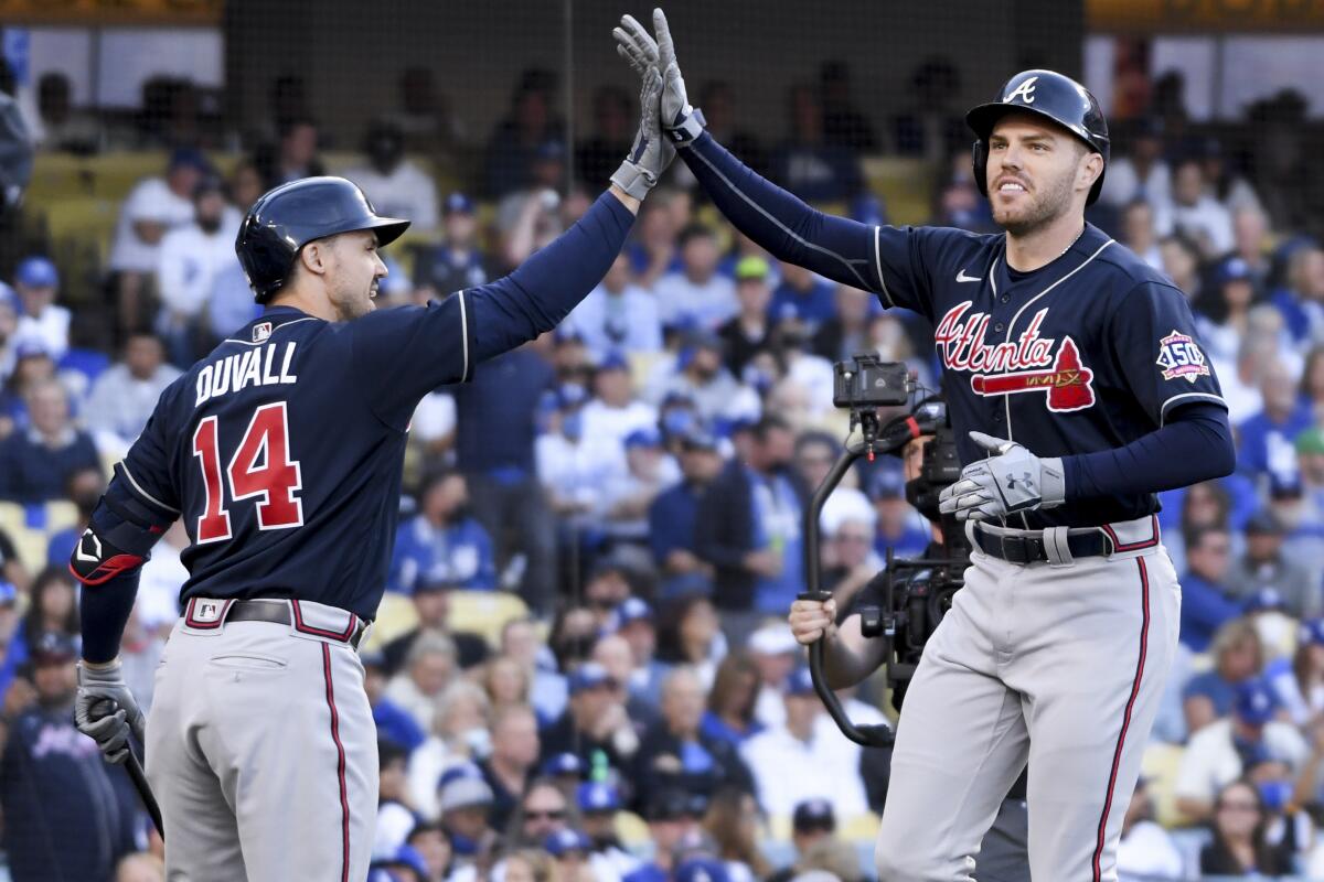 The Braves' Freddie Freeman celebrates with Adam Duvall after a two-run homer.