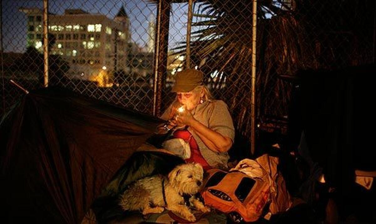 Joanna Said settles in with her dog, Jackie Onassis, and lights up a last cigarette before going to sleep along a Hollywood street. She said she's 67 and has little hope of putting her life back on track. "I'm one of the people who should not be homeless," she said. "Who's going to hire me to do anything?" More photos >>>