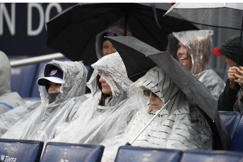 Fans watch the Philadelphia Phillies play against the Washington Nationals in a baseball game, Sunday, Oct. 2, 2022, in Washington. (AP Photo/Luis M. Alvarez)