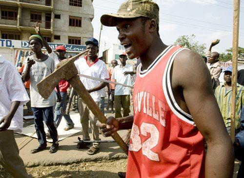 A man carrying an ax joins supporters of Kenya's opposition leader, Raila Odinga, in the streets of Kisumu.