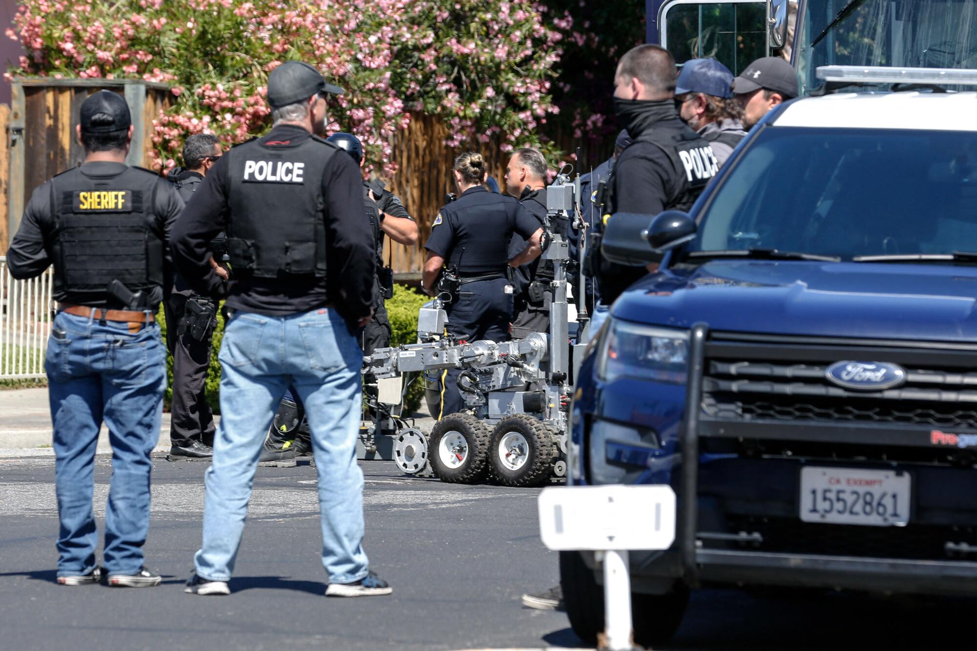 A rolling machine appears among law enforcement officers.