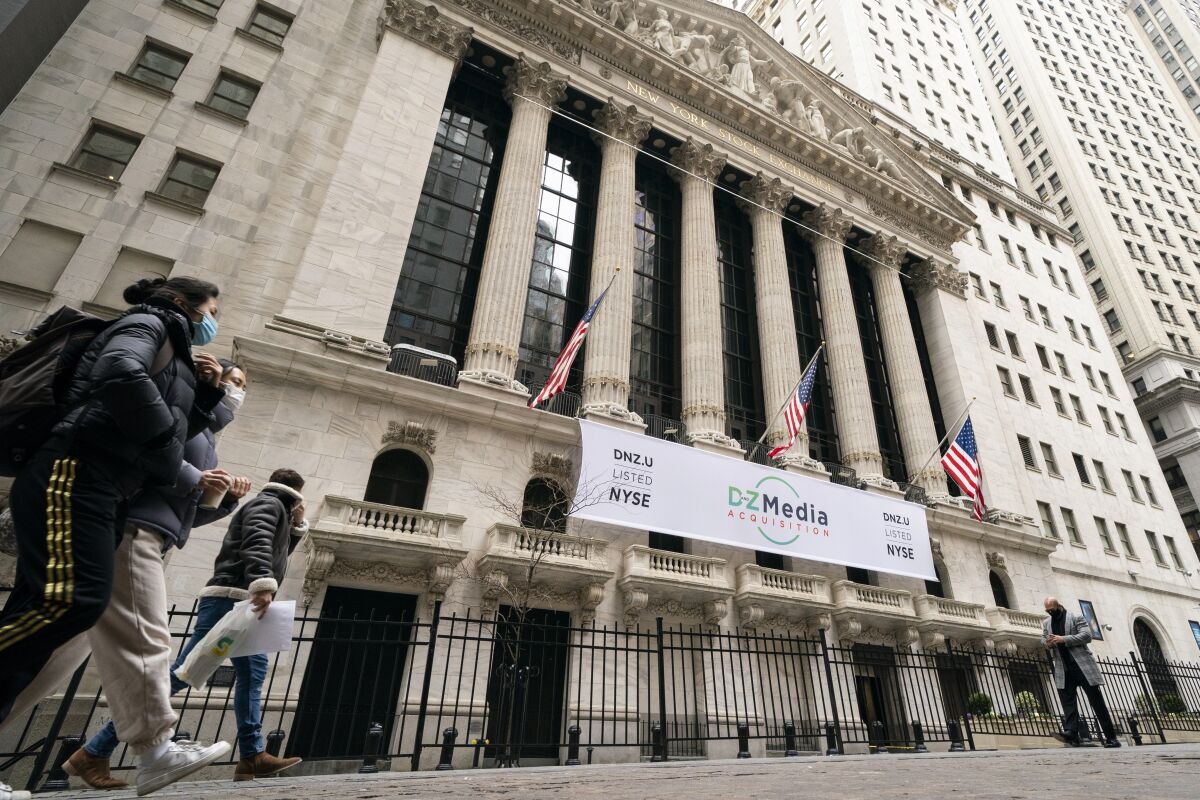 FILE - In this Jan. 27, 2021 file photo, pedestrians pass the New York Stock Exchange in New York. Stocks were solidly lower in early trading Tuesday, May 4, dragged down by banks and big technology companies like Apple and Google. (AP Photo/John Minchillo, File)