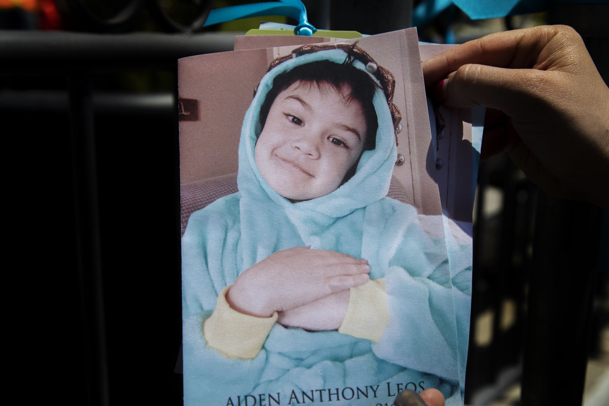 A photograph of 6-year-old Aiden Leos covers his memorial service program.