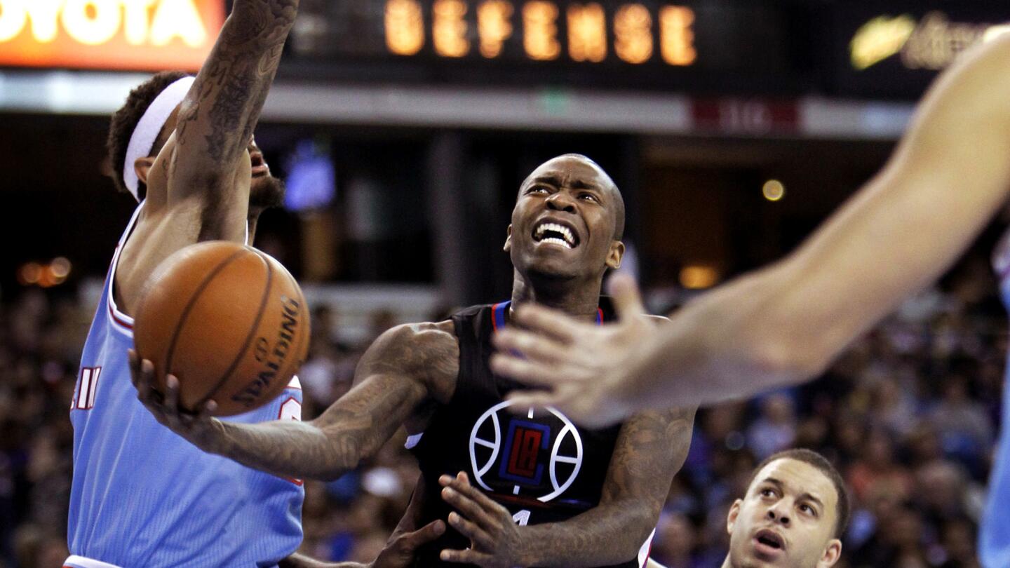 Clippers guard Jamal Crawford attempts a layup after driving against Kings center Willie Cauley-Stein, left, and Seth Curry during the first half.