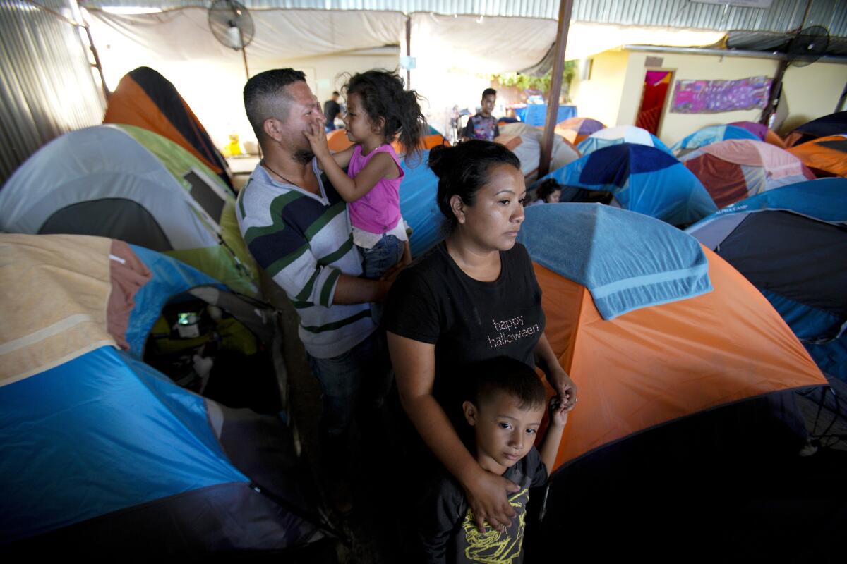 Gustavo Loza and his wife, Leidy Rivas, arrived in Tijuana after traveling for more than a month from El Salvador. The couple arrived with their two children, Katerine, 4, and Hamilton, 5, and are waiting to see if they can stay at the Movimiento Juventud shelter.