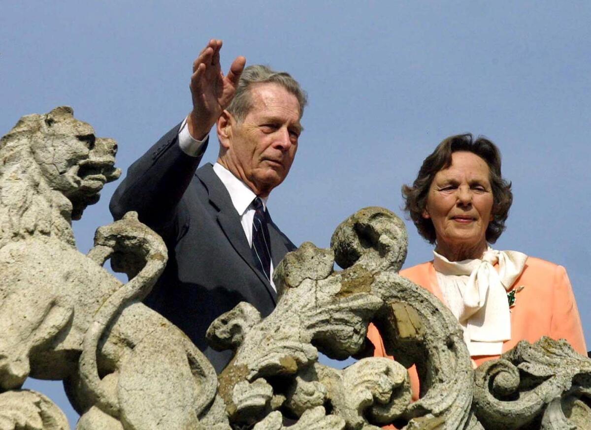 King Michael I of Romania waves to supporters next to his wife Queen Anne of Bourbon-Parma from the balcony of the Elisabeta Palace in Bucharest, Romania, in 2001.