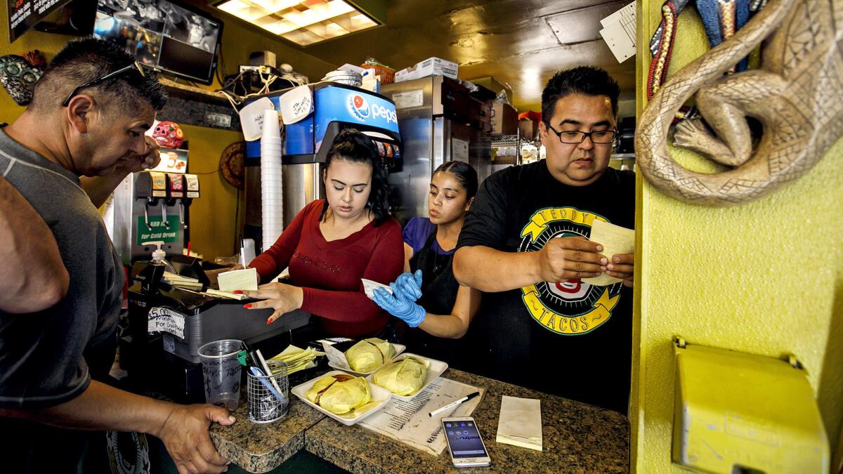 Lesly Madrid, from left, Veronica Juarez and Teddy Castro work behind the counter at Teddy's Tacos in City of Industry.