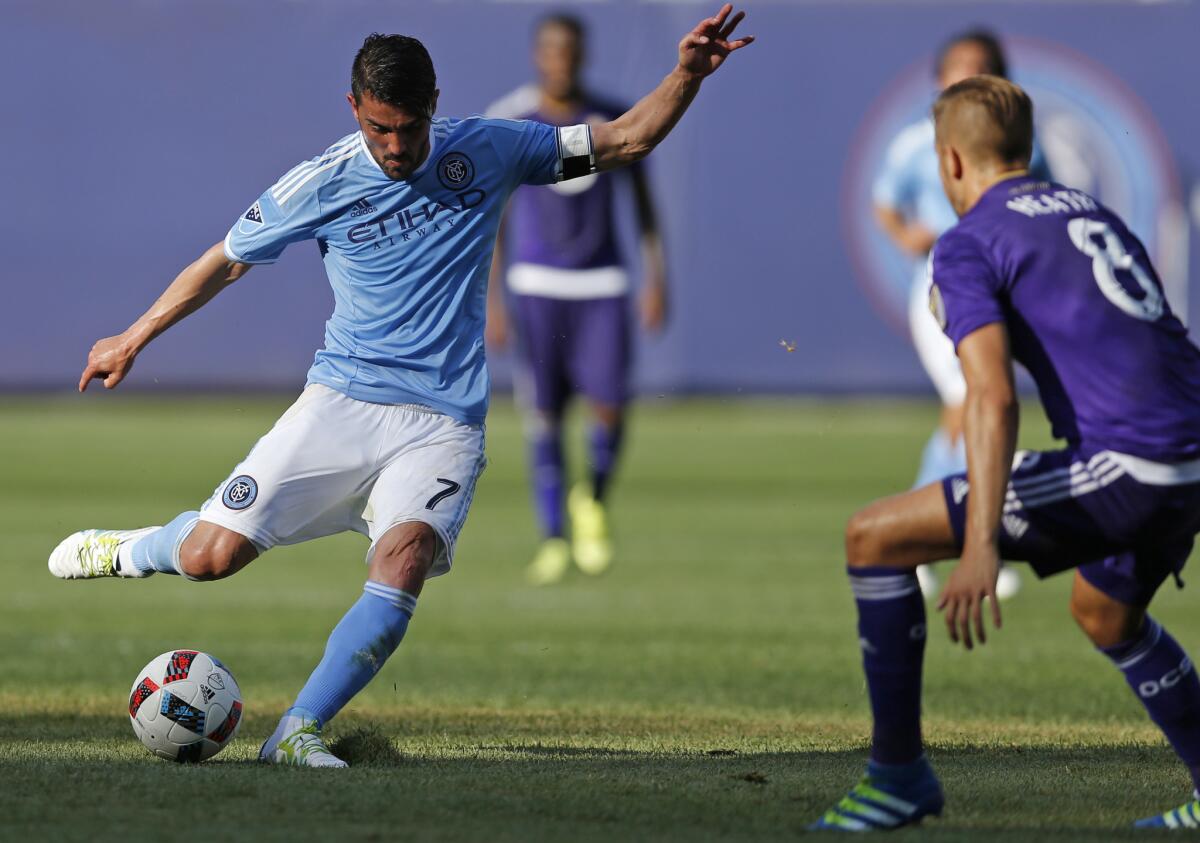 In this May 29, 2016 file photo, New York City FC forward David Villa shoots against Orlando City FC midfielder Harrison Heath, in the second half of an MLS soccer match, in New York. Villa was named MLS MVP for the 2016 season, Tuesday, Dec. 6, 2016.