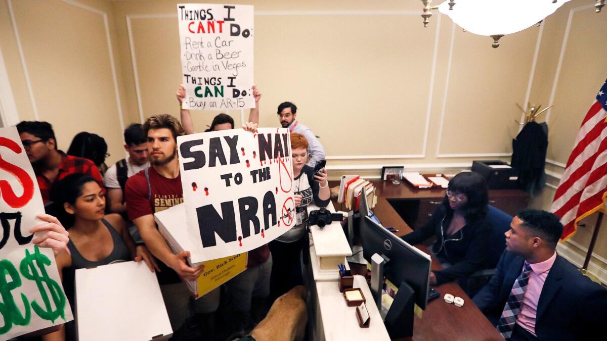High school students demonstrate at the entrance to Florida Gov. Rick Scott's office and deliver boxes of petitions for more gun control on Feb. 21.