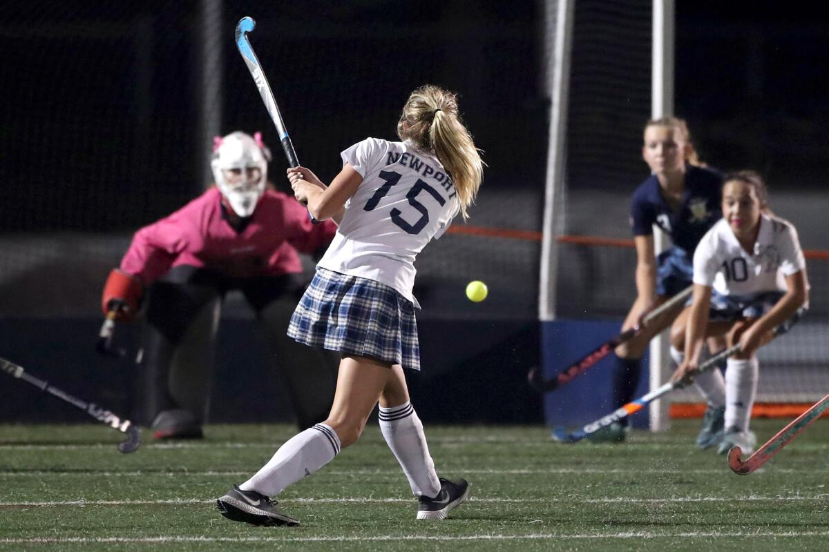 Newport Harbor's Lucy Toohey (15) shoots a shot, that was tipped by Bridget Taketa (10), right, for a goal.