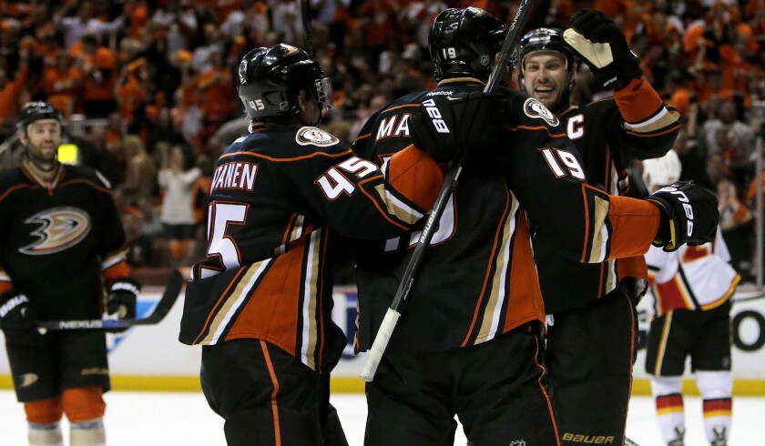Ducks left wing Patrick Maroon (19) celebrates with defenseman Sami Vatanen and center Ryan Getzlaf after scoring against the Flames in the first period of Game 1.