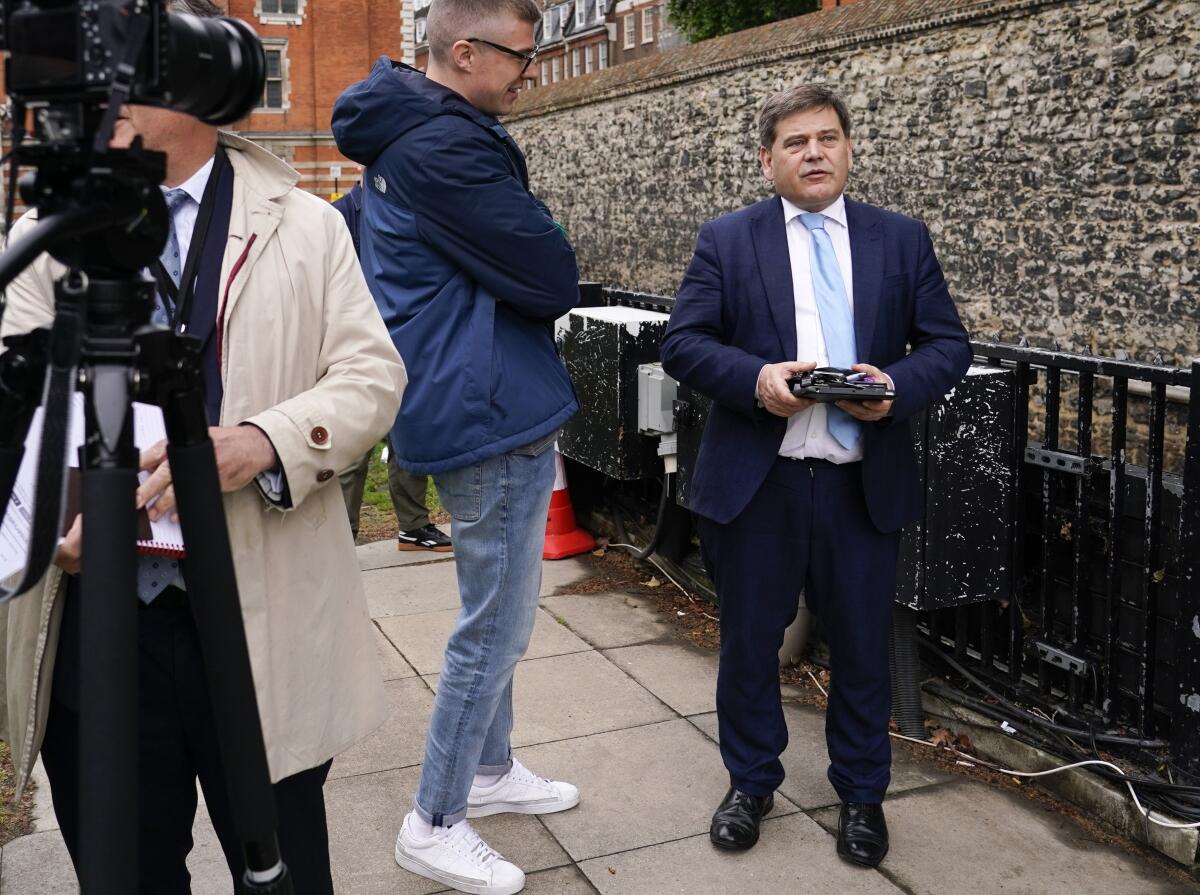 FILE - British lawmaker Andrew Bridgen speaks to the media outside the Houses of Parliament, in London, on June 6, 2022. Britain’s governing Conservative Party on Wednesday, Jan. 11, 2023, suspended Bridgen, who spread misinformation about COVID-19 vaccines and compared the inoculations to the Holocaust. (AP Photo/Alberto Pezzali)