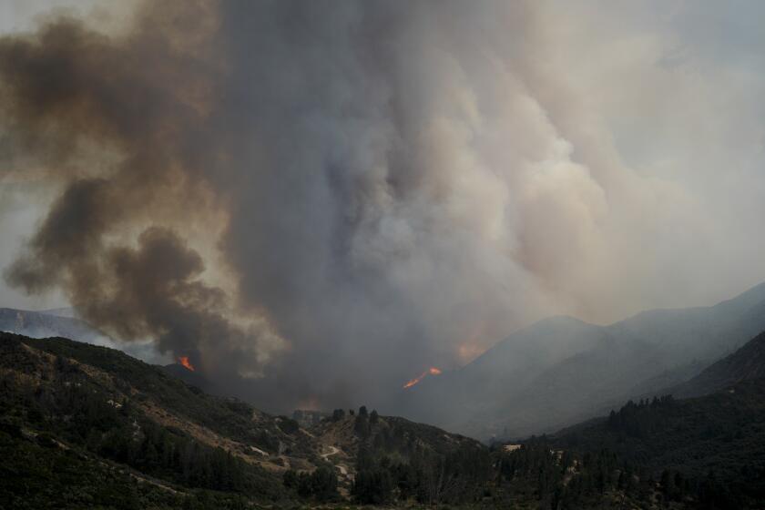 Smoke rises from the Line Fire over the mountains Saturday, Sept. 7, 2024, in Running Springs, Calif. (AP Photo/Eric Thayer)