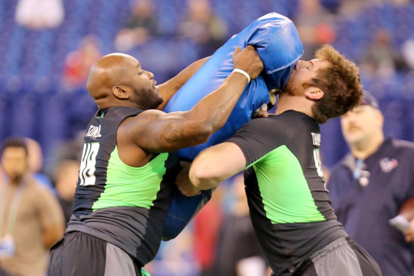 Mississippi offensive lineman Laremy Tunsil hits a pad during a drill at the NFL scouting combine on Feb. 26.