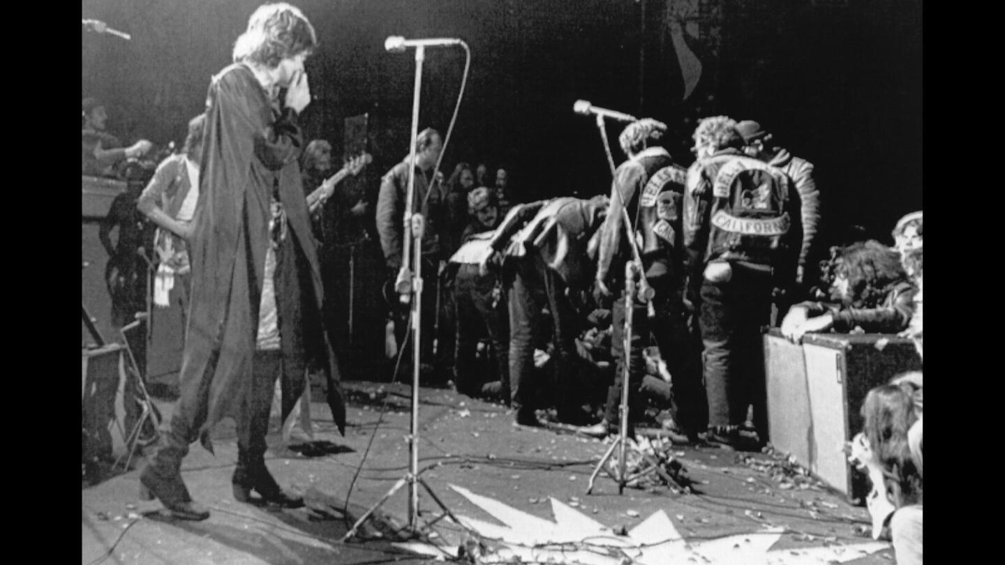 Mick Jagger stops performing at the Altamont festival at Livermore as Hells Angels cross the stage during a melee to help fellow motorcyclists.
