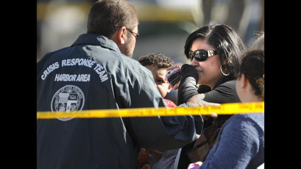 L.A.'s Crisis Response Team helps an unidentified woman outside a home in Wilmington where seven people were found dead. The volunteer service is designed to comfort those the police usually pay the least attention to: "surviving victims," the family and friends who have to go on with their lives after disaster strikes.