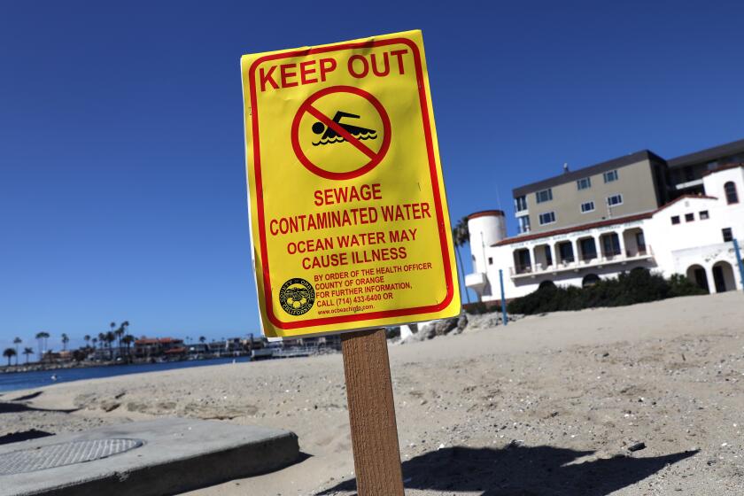 NEWPORT BEACH-CA-MARCH 16, 2021: Orange County health officials have closed a roughly half-mile section of the Newport Beach coast to ocean sports due to a sewage spill, as seen on a sign posted in China Cove Beach on Tuesday, March 16, 2021. Approximately 1,000 gallons of sewage spilled into the Newport Bay after an operator error during routine maintenance of a sewer main line in Newport Beach, the Orange County Health Agency said in a new release Monday. (Christina House / Los Angeles Times)