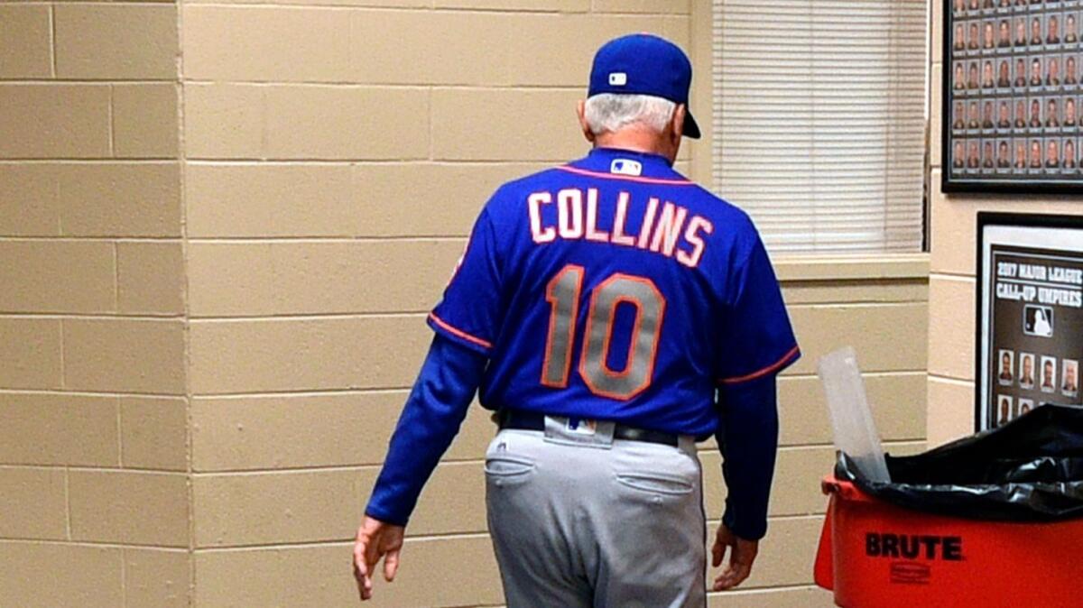 New York Mets manager Terry Collins walks from his office after resigning as manager following Sunday's game against the Philadelphia Phillies.
