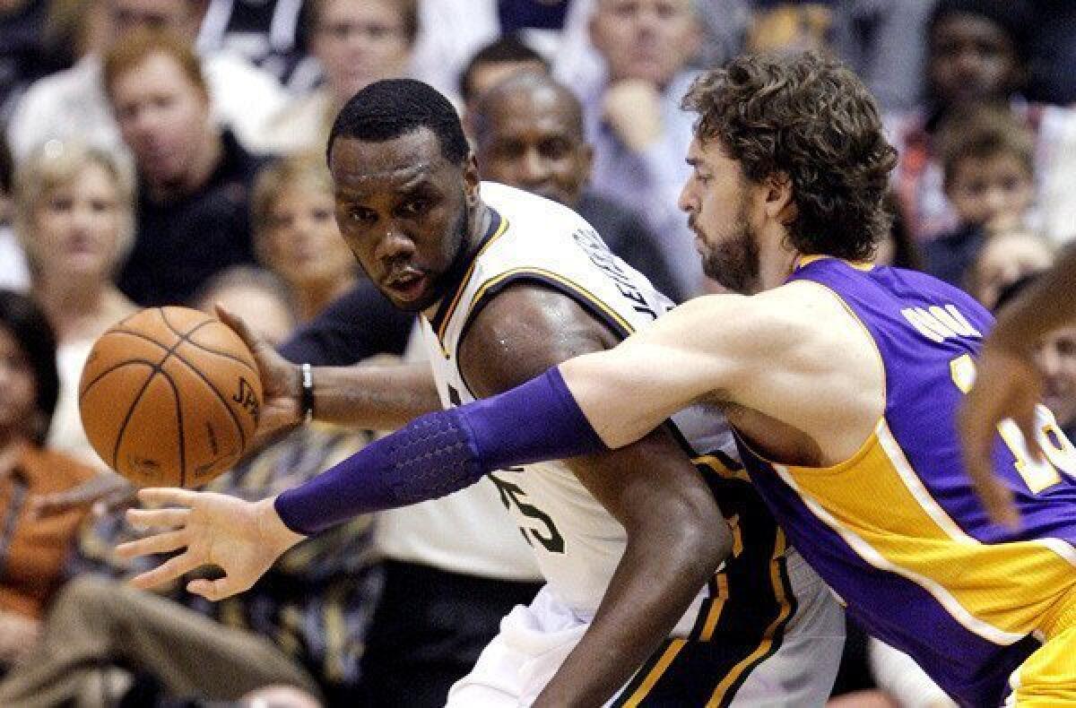 Lakers power forward Pau Gasol tries to cut off a drive by Jazz center Al Jefferson in the first half Wednesday night in Utah.