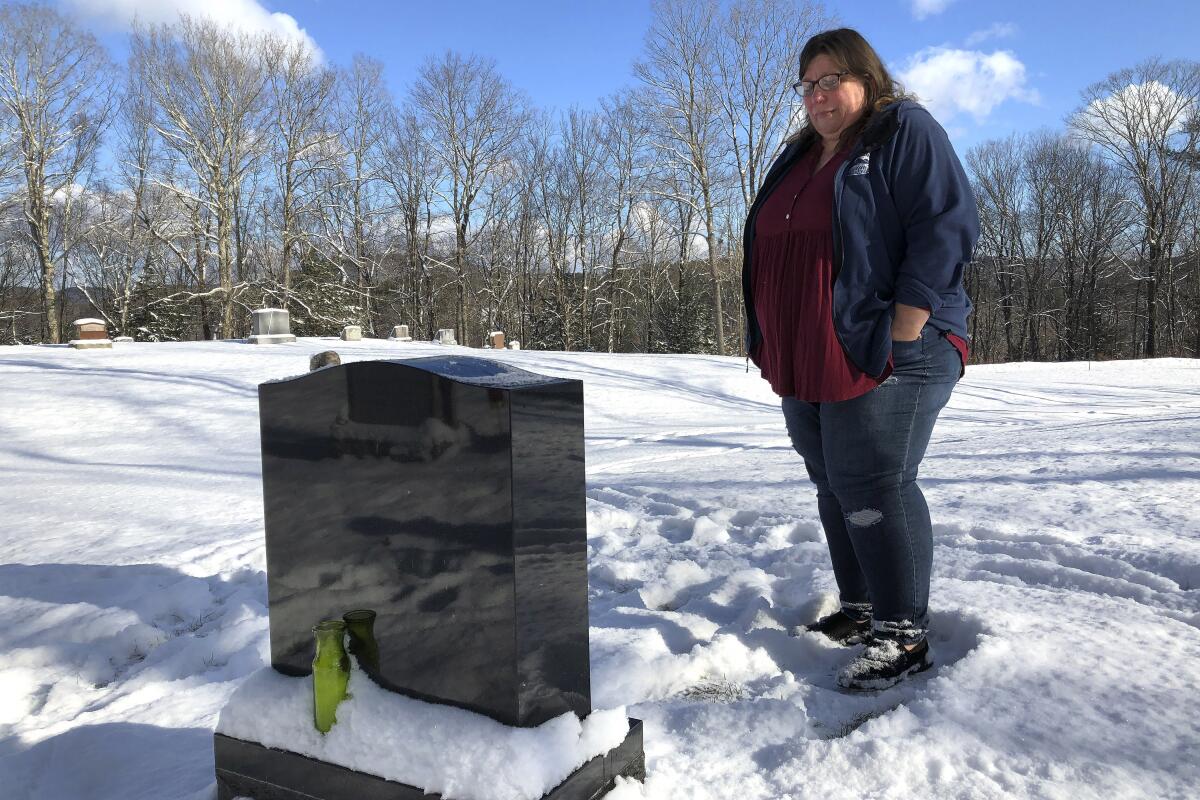 A woman visits the grave of her daughter